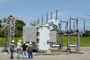 Southwest Electric technicians inspecting a transformer in the field, ensuring operational safety and efficiency.